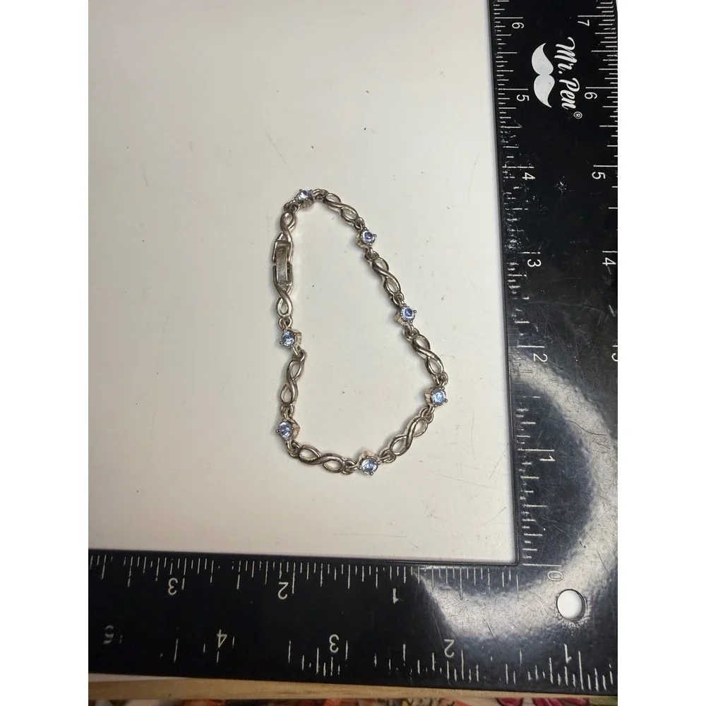 NRT Silver Tone Infinity Link Bracelet Light Blue Crystal Bezel Set 7.25 Inch